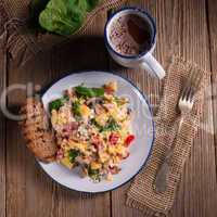 Scrambled eggs with tomatoes and spinach