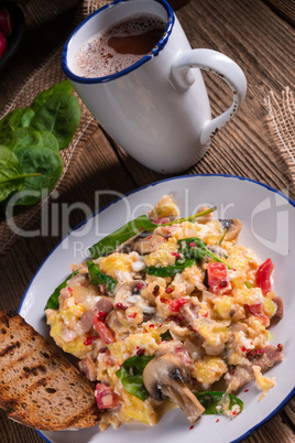 Scrambled eggs with tomatoes and spinach