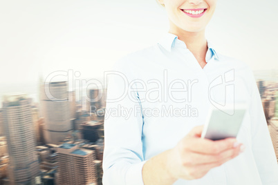 Composite image of businesswoman using her mobile phone