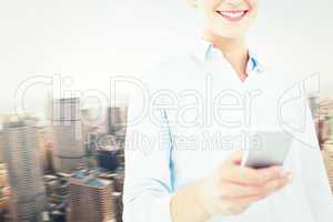 Composite image of businesswoman using her mobile phone