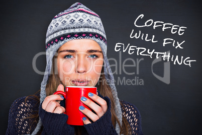 Composite image of beautiful woman in warm clothing drinking cof