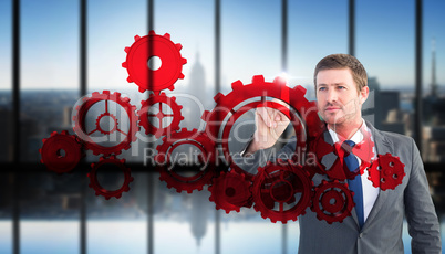 Composite image of focused businessman pointing with finger