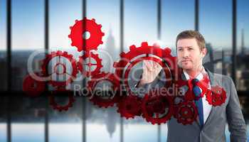 Composite image of focused businessman pointing with finger