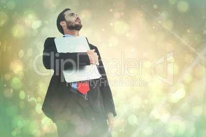 Composite image of concentrating businessman in suit holding lap