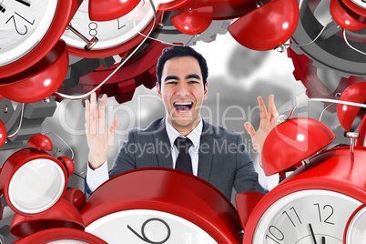 Composite image of excited businessman with arms raised