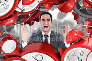 Composite image of excited businessman with arms raised