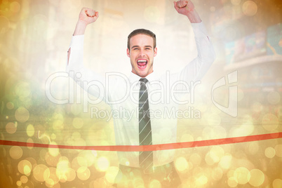 Composite image of businessman crossing the finish line and chee