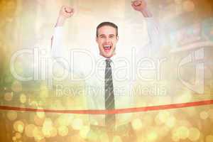 Composite image of businessman crossing the finish line and chee