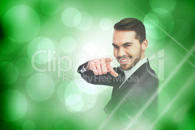 Composite image of happy businessman pointing his finger