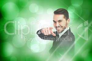 Composite image of happy businessman pointing his finger