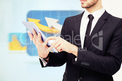 Composite image of mid section of a businessman using digital ta