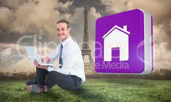 Composite image of happy businessman sitting and using laptop