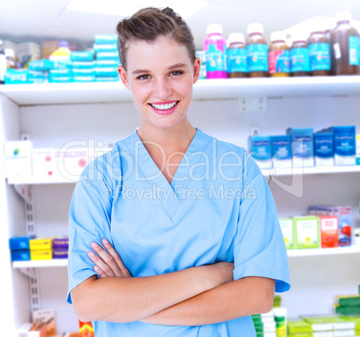 Composite image of  smiling nurse in blue scrubs posing with arm