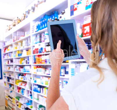 Composite image of woman using tablet pc