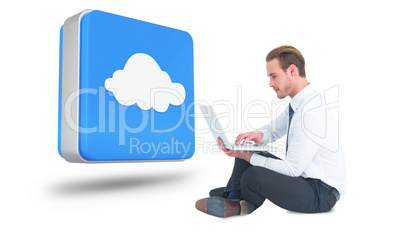 Composite image of smiling businessman sitting on floor using la