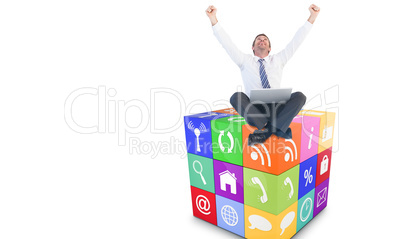 Composite image of excited cheering businessman sitting using hi