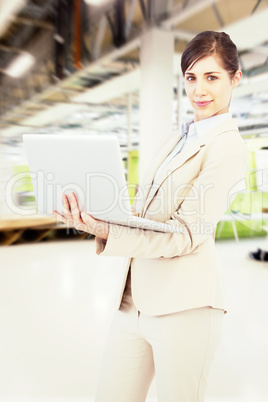 Composite image of confident young businesswoman with laptop