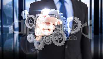 Composite image of businessman pointing his finger at camera