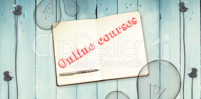 Online courses against notepad and bulbs on wooden background