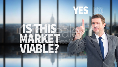 Composite image of focused businessman pointing with finger