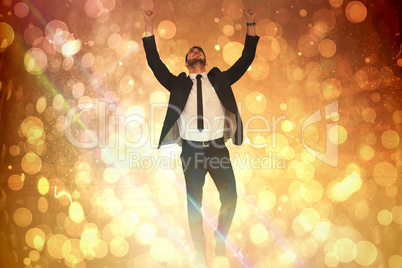 Composite image of cheerful businessman with arms up cheering