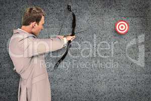 Composite image of businessman shooting target