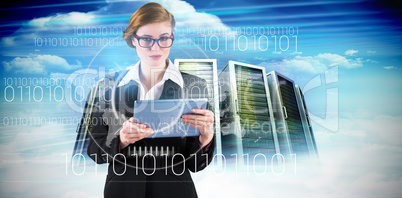 Composite image of redhead businesswoman using her tablet pc