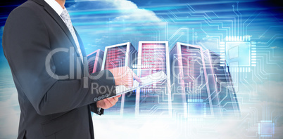 Composite image of businessman using his tablet pc