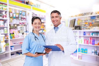 Composite image of doctor and nurse smiling at camera