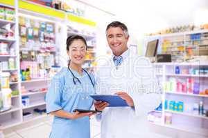 Composite image of doctor and nurse smiling at camera