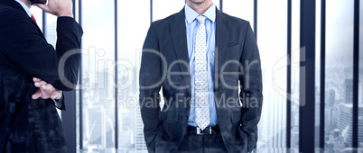 Composite image of businessman looking at the camera