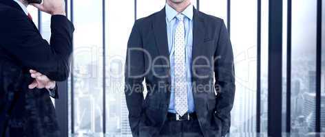 Composite image of businessman looking at the camera