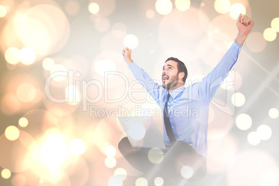 Composite image of excited cheering businessman sitting using hi