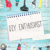 Diy enthusiast against tools and notepad on wooden background