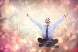 Composite image of businessman cheering with tablet sitting on f