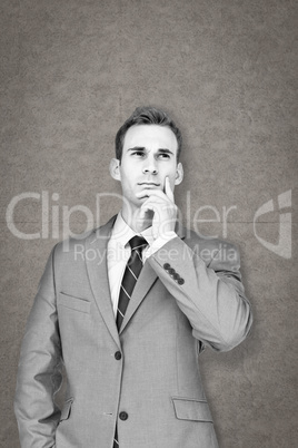 Composite image of businessman thinking