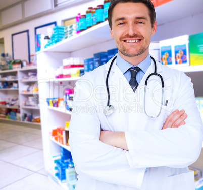 Composite image of handsome young doctor with arms crossed