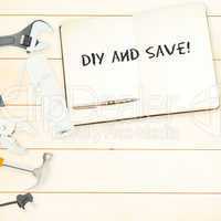 Diy and save! against tools and notepad on wooden background