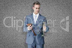 Composite image of businessman holding scales of justice