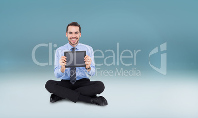 Composite image of smiling businessman showing his digital table