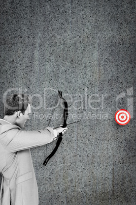 Composite image of businessman shooting target