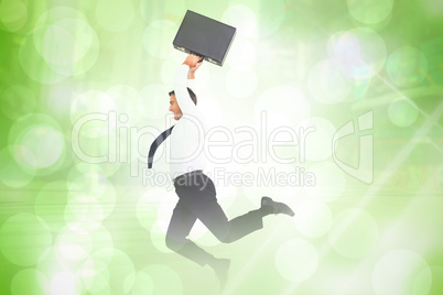 Composite image of smiling businessman leaping while briefcase