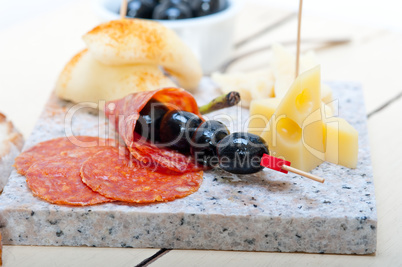 mix cold cut on a stone with fresh pears