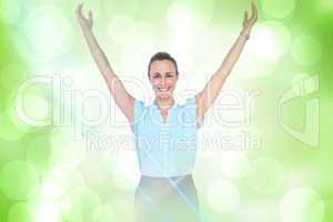 Composite image of businesswoman with arms raised