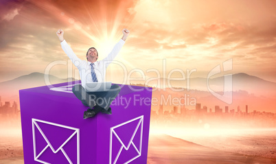 Composite image of excited cheering businessman sitting using hi