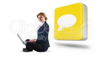 Composite image of redhead businesswoman using her laptop