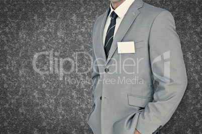 Composite image of businessman with badge