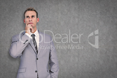 Composite image of businessman thinking