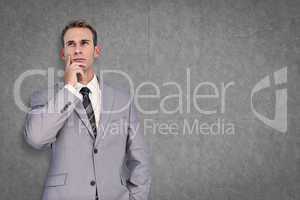 Composite image of businessman thinking