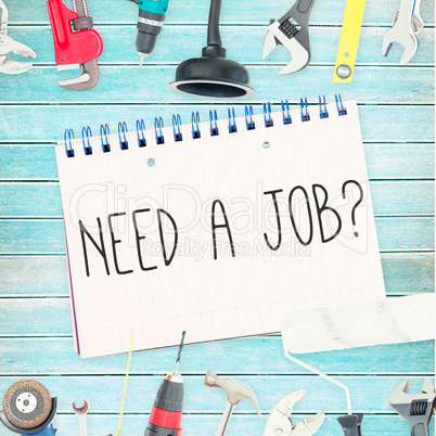 Need a job? against tools and notepad on wooden background